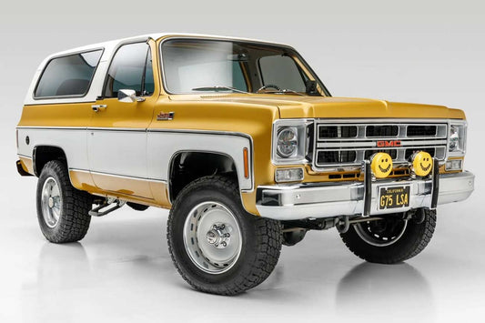 Restored 1975 GMC Jimmy in gold and white two-tone paint with original GMC grille and chrome trim