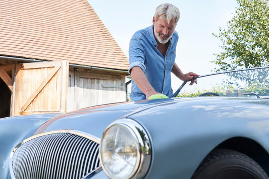 Man polishing classic car