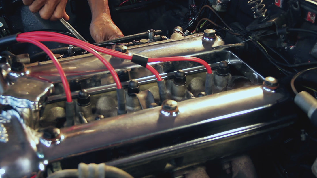 Load video: Man cleaning classic car engine.